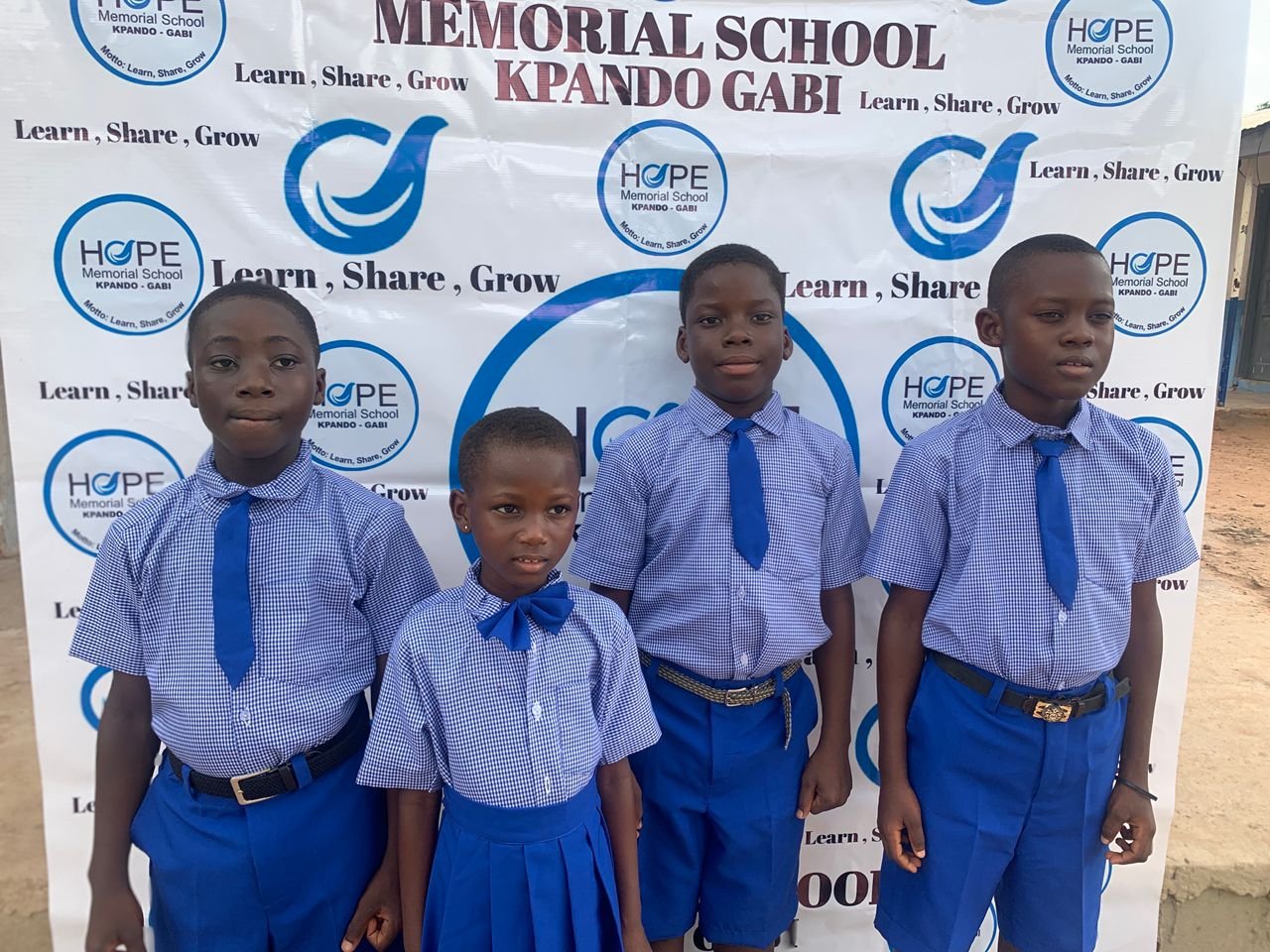 Teacher supporting children at Hope Memorial School