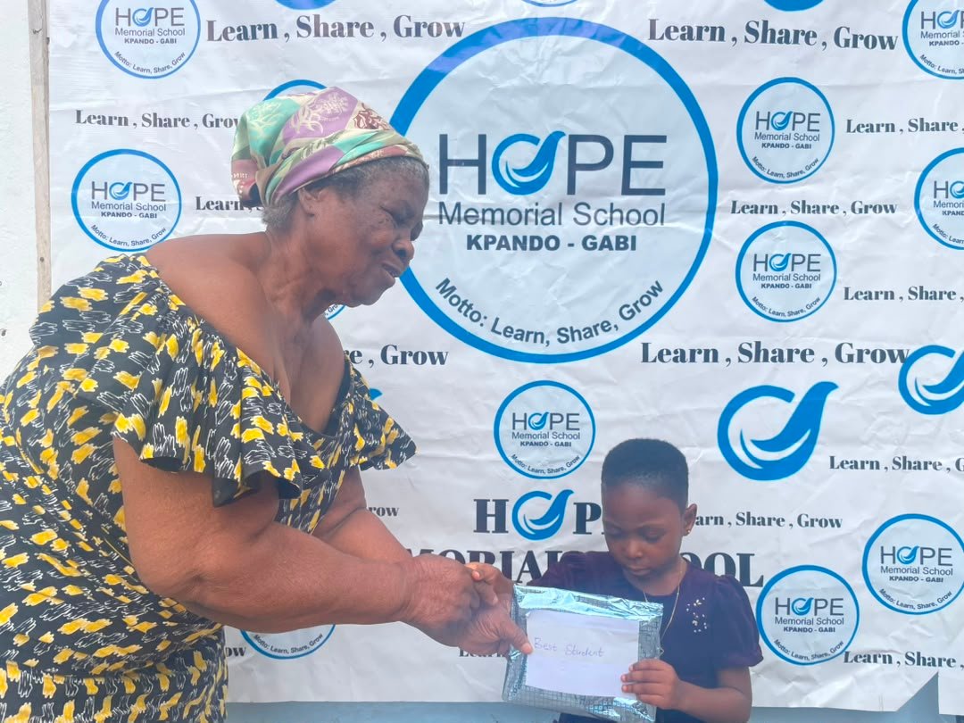Learner receiving gift at Hope Memorial School from the Founder